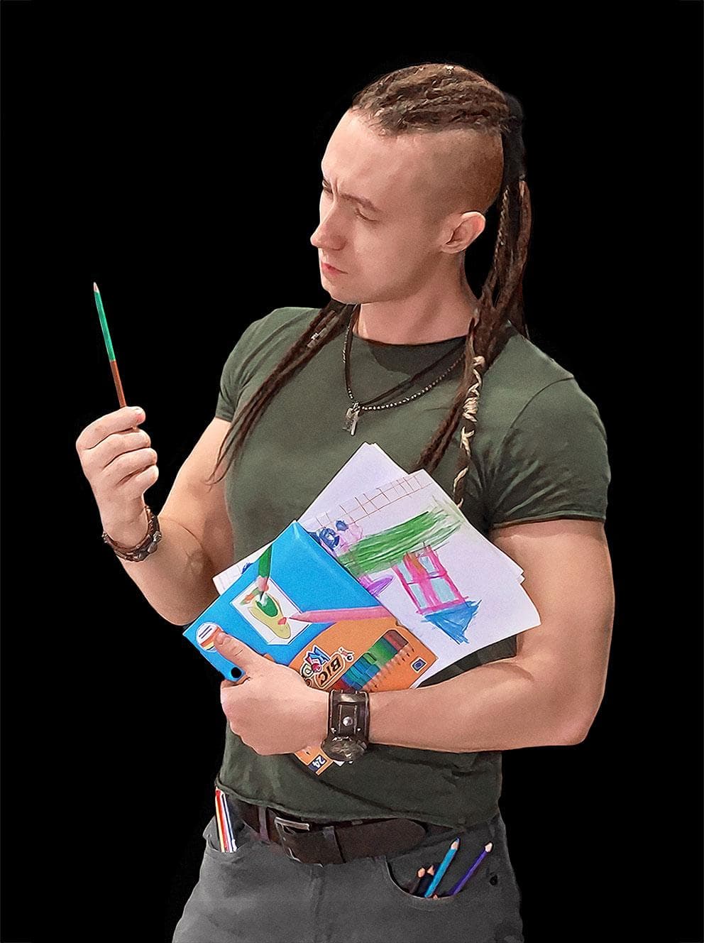 Daniel Wasiluk, who is wearing a wearing an olive-colored t-shirt with gray jeans, and is holding a stack of children's drawings in his left hand while staring quizically at a teal colored-pencil that he is holding in his right hand